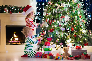 Kids next to Christmas tree